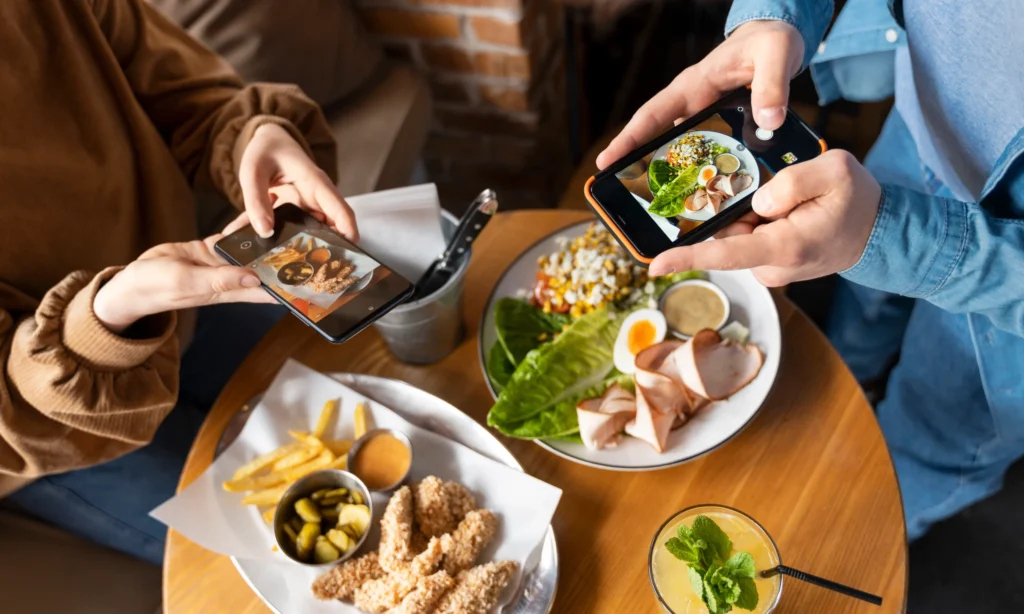 Influencers taking pictures of food content for social media and influencer marketing campaigns.